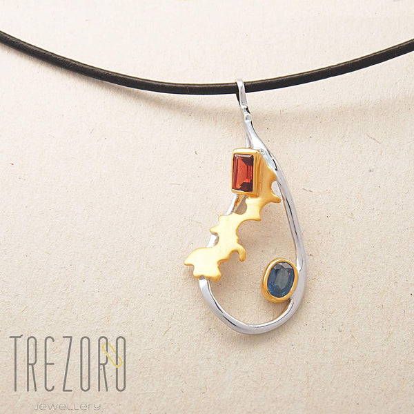 Adventure Road Designer Pendant. Sterling Silver with  Garnet and Sapphire, Rhodium and Gold Plated. On grey.